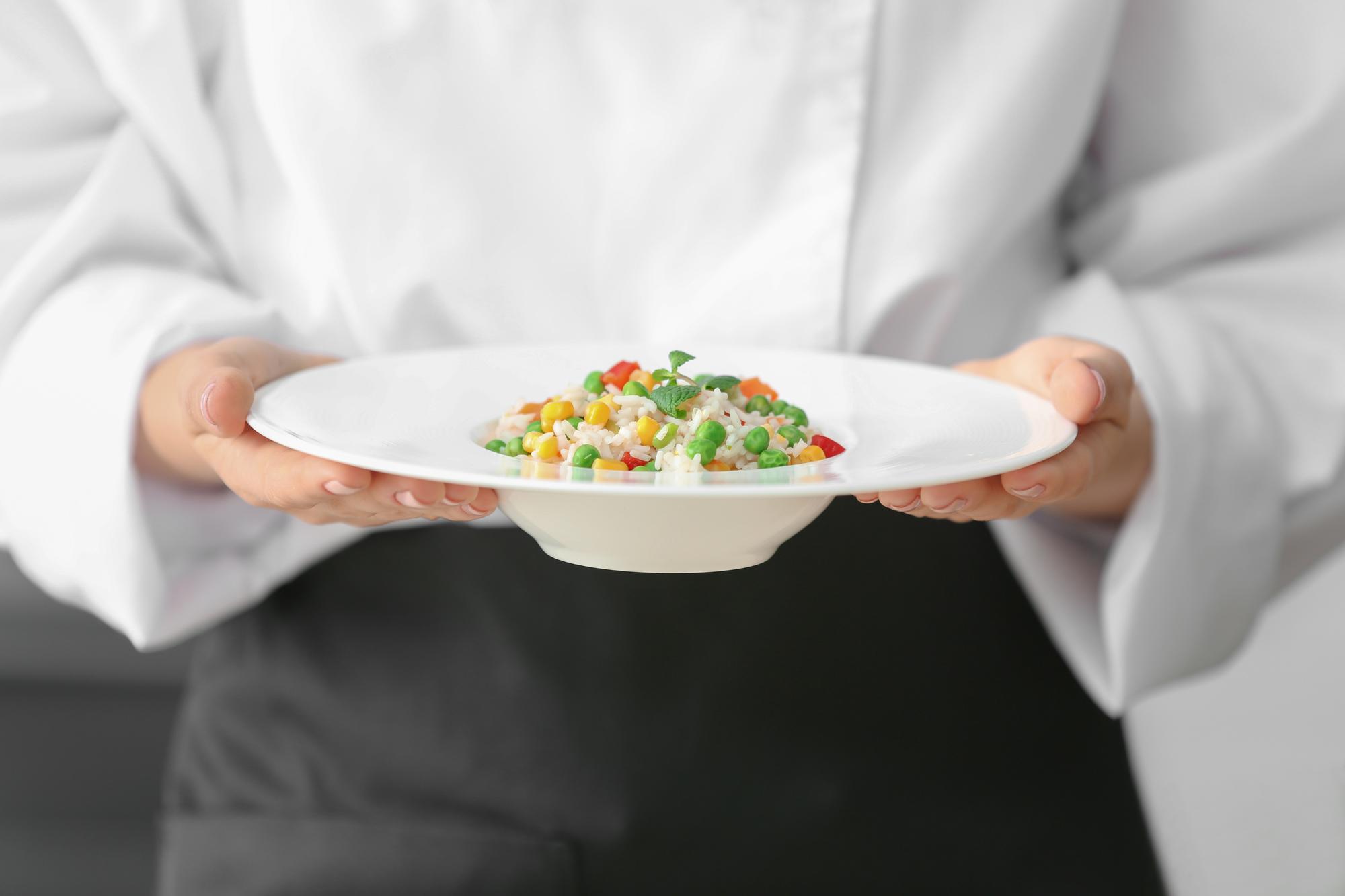 Hands presenting tasting plates